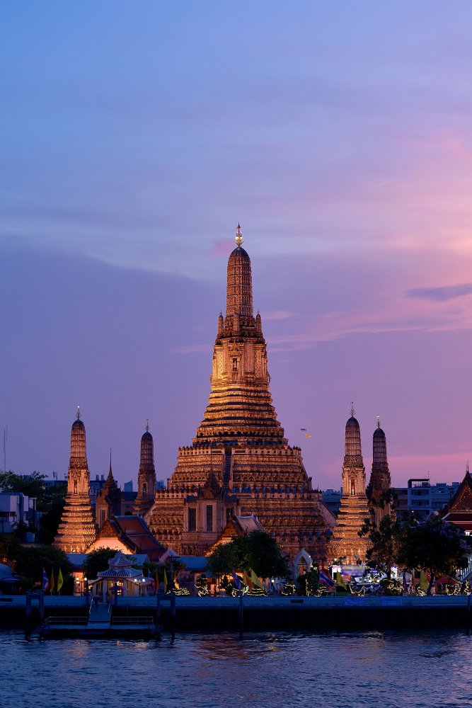 Temple of the Dawn, Wat Arun, on the bank of Chao Phraya River at sunset, twilight, view from the river, Vertical
