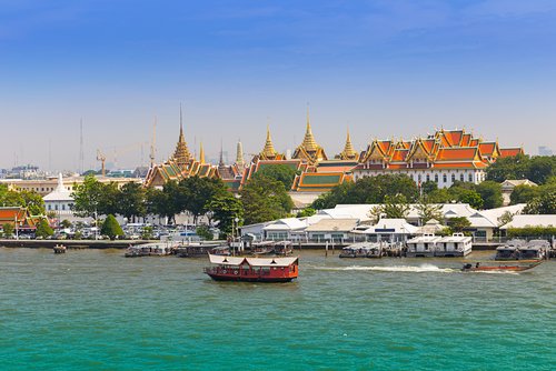 Grand palace by long tail boat on the Chao Phraya River in Bangkok, Thailand