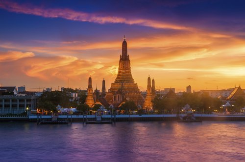 Wat Arun Ratchawararam is a beautiful temple, the great pagoda in the evening at the magnificent light and beautiful golden sky.
